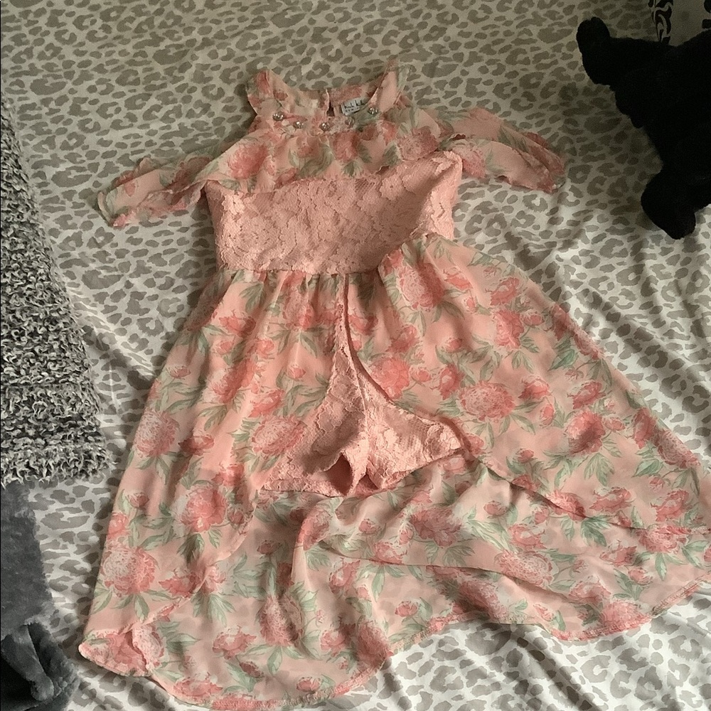 This is a beautiful dress that has a pink romper built into it.